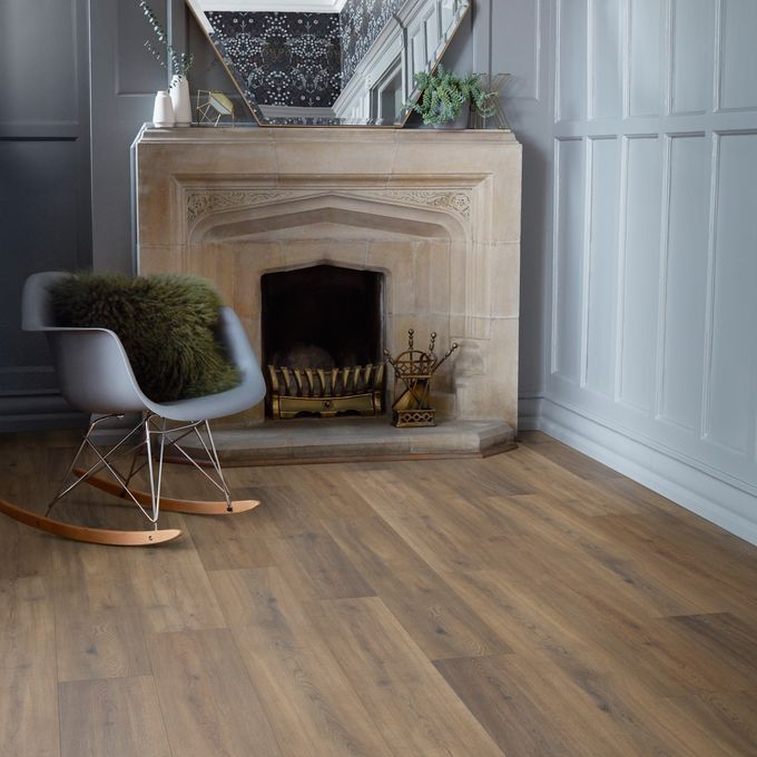 Oak effect flooring in a room with a fire and chair