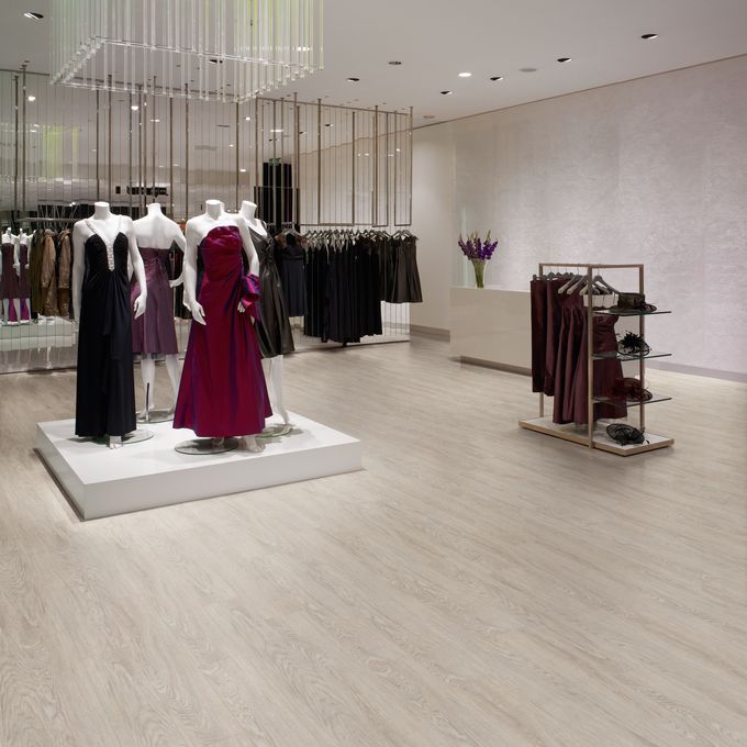 Modern retail store dress display with light oak flooring 