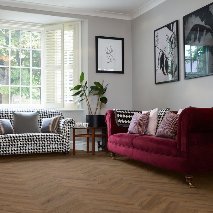 Dark oak effect flooring laid in a large parquet style within a front room