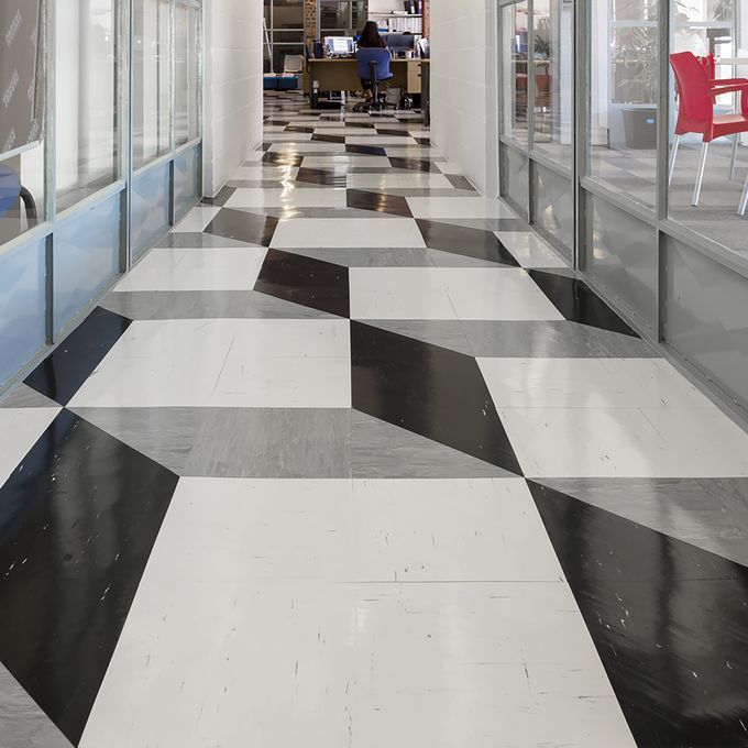 Black, Grey and white patterned flooring in a school corridor