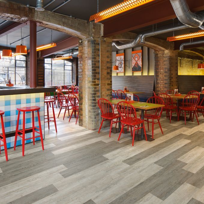 Restaurant dining area with open brick walls and Grey Oak and White Oak flooring creating a design floor pattern