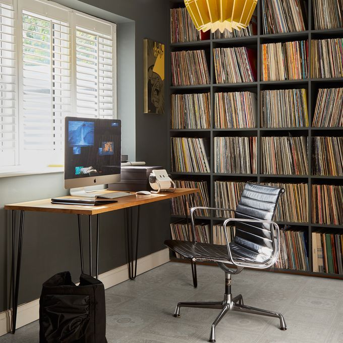 Stujdy room with a large bookcase and light coloured Persian loom effect flooring