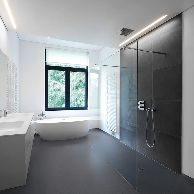 Dark coloured safety flooring in a large modern bathroom