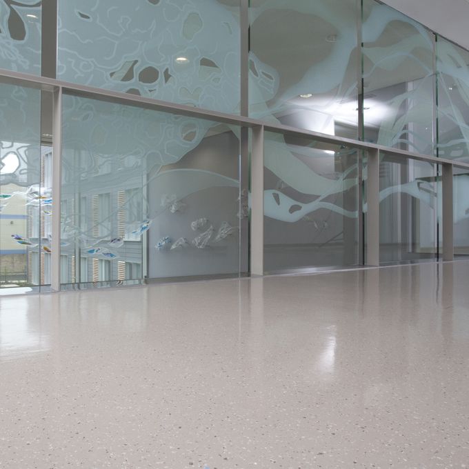 Large hospital corridor with neutral coloured flooring