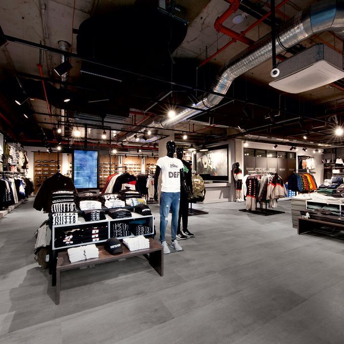Dark grey coloured flooring in a clothing retail store