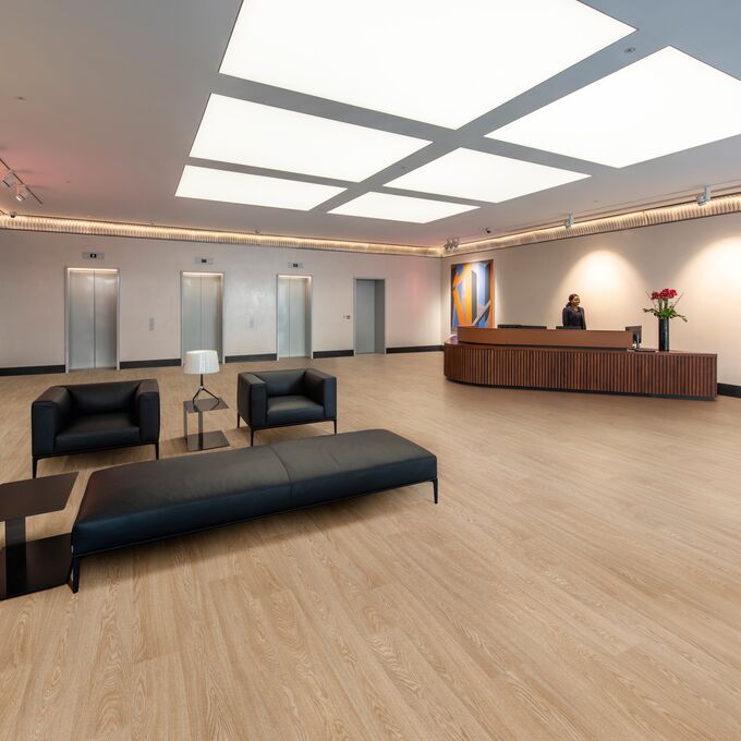 Oak effect flooring laid in an open reception area