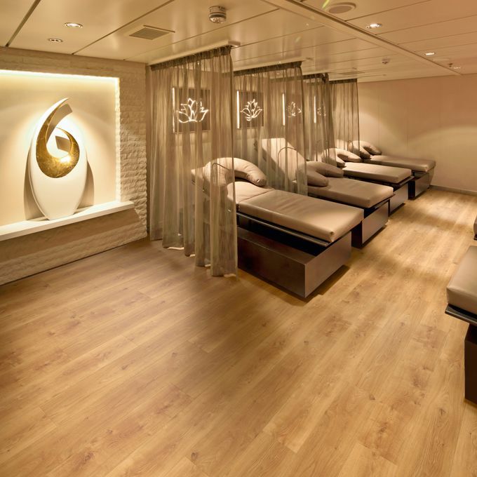 Therapy room with massage beds featuring a ligh oak effect flooring 