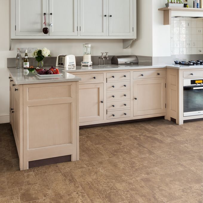 Brown paving effect flooring in a open plan residential kitchen