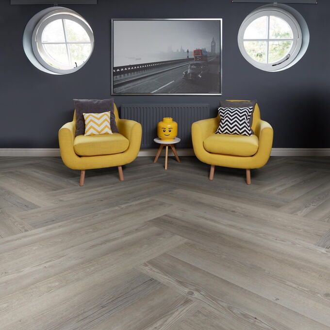 TLC Massimo in Priory Oak laid in a room with two yellow chairs 