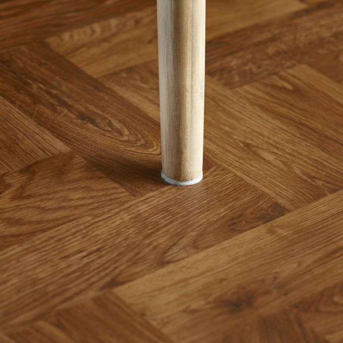 Close up of dark oak wood effect flooring in Parquet style