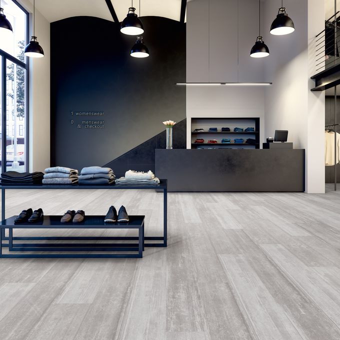 Grey coloured wood effect flooring in a clothing retail store