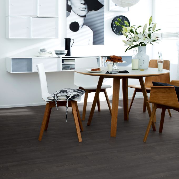 Dark oak wood effect flooring in a modern dining area in a family home