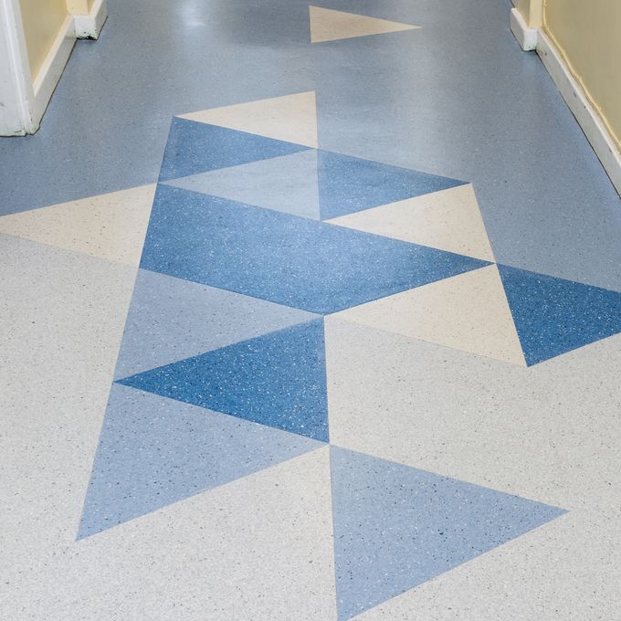 Mixed blue triangle design flooring in a corridor 