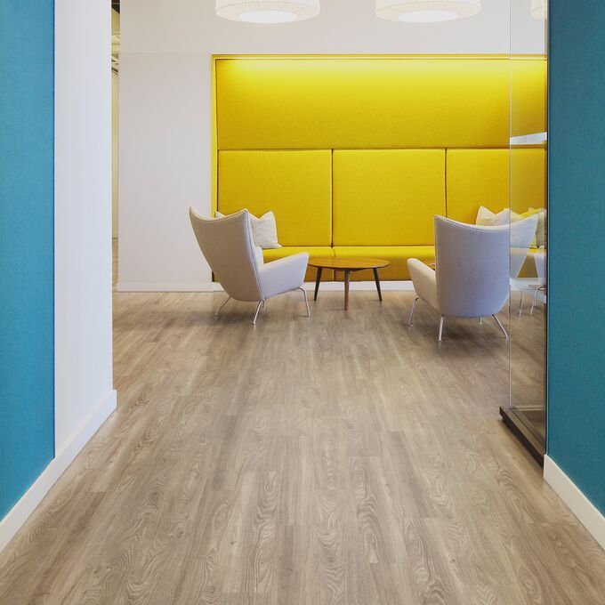 Light elm effect flooring in a corridor with blue and yellow walls