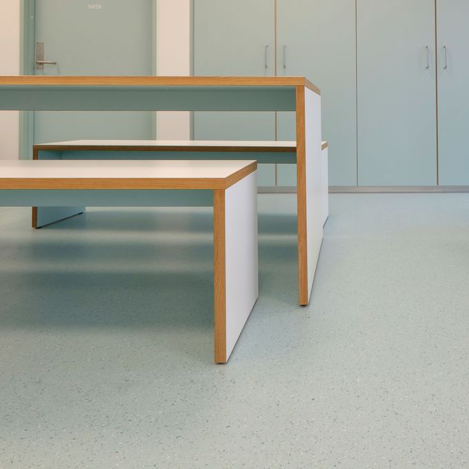 Educational setting seating area with light green coloured flooring