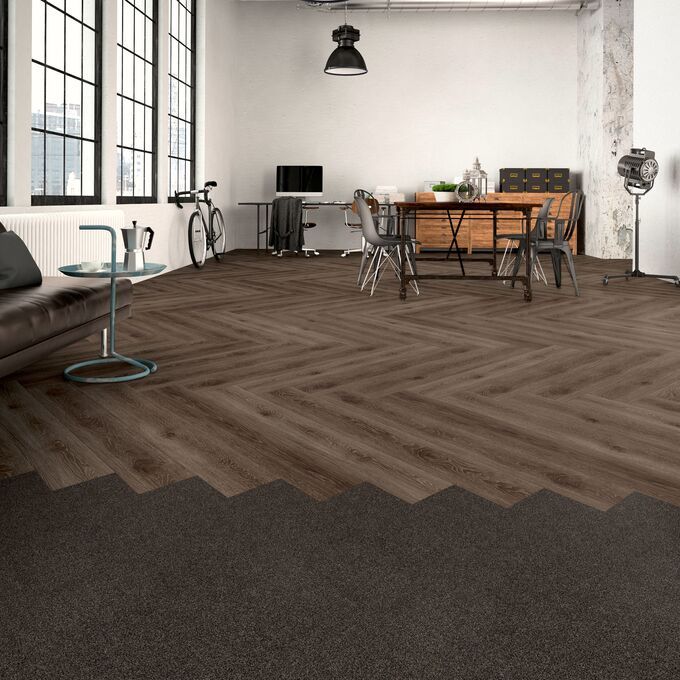 Dark oak effect flooring laid i a parquet style in a modern office
