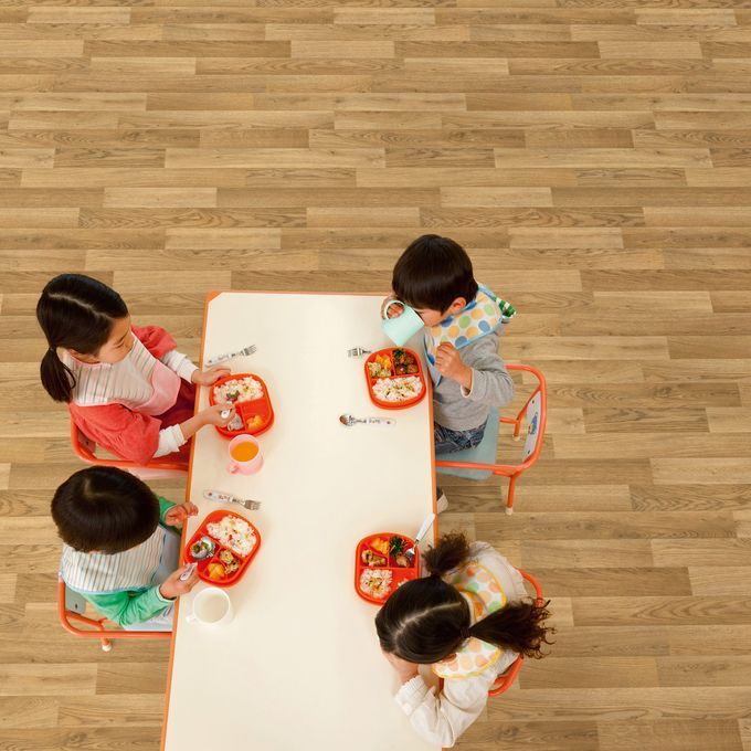 Overhead shot of children sat at a table eating lunch