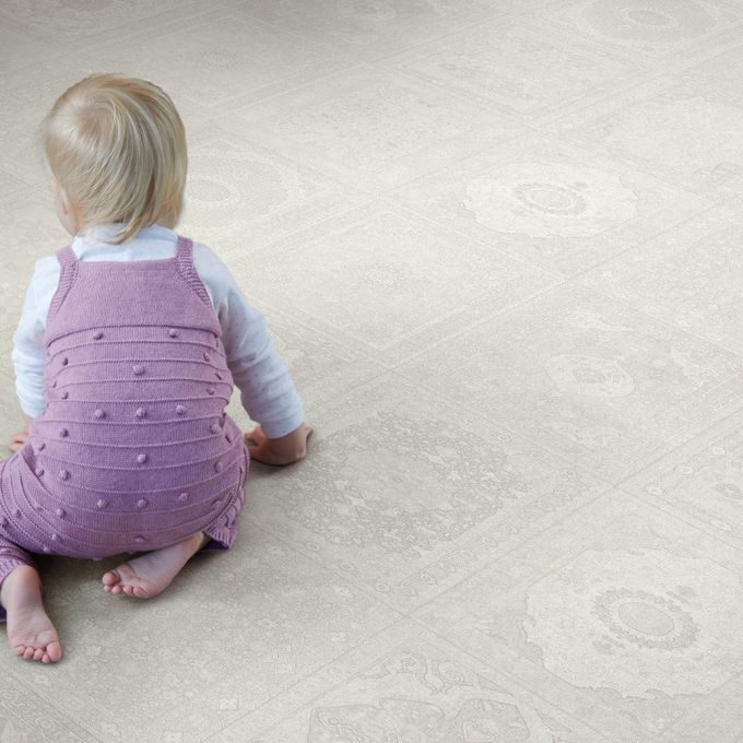 Light coloured flooring with a baby crawling