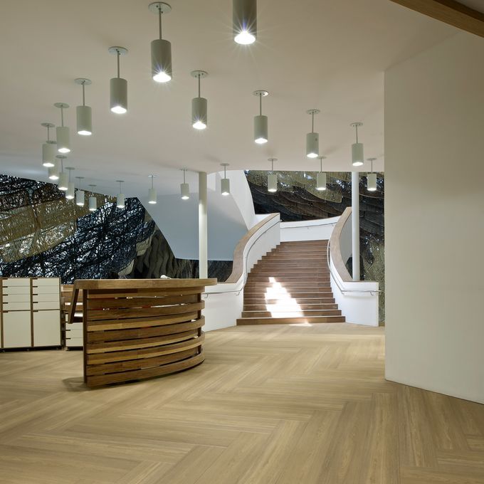Commercial indoor open space with staircase and wood effect flooring