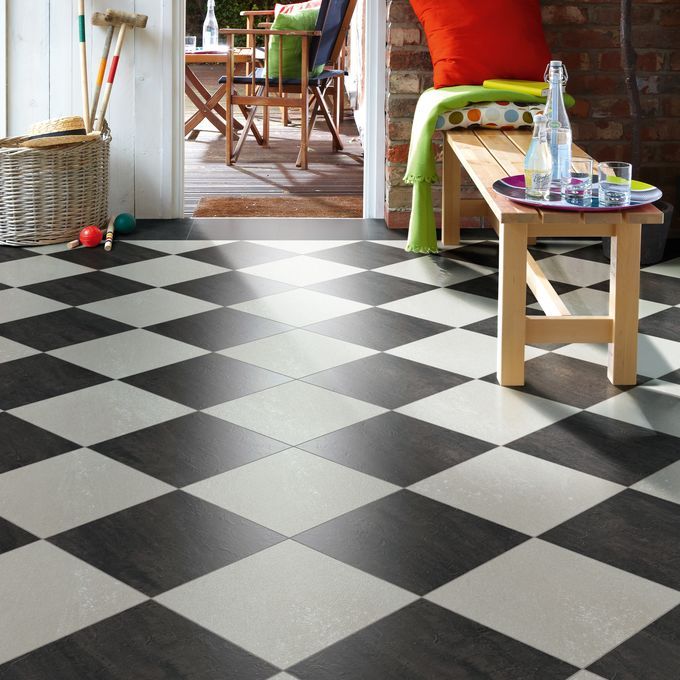 Dark slate and White slate tiles laid in a chess board style in a family home 