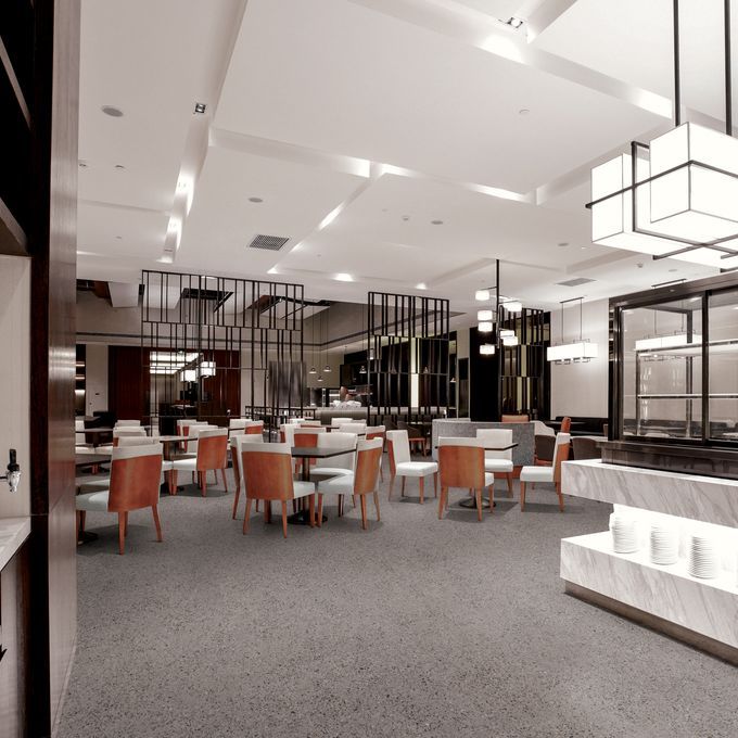 Dark grey coloured flooring in a restaurant with burnt orange coloured chairs and modern lighting