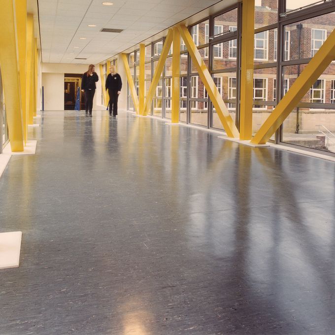 Large commercial corridor with dark coloured flooring