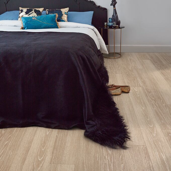 Bedroom, Kingsize bed, Black headboard, quilt, pillows, oak floor 