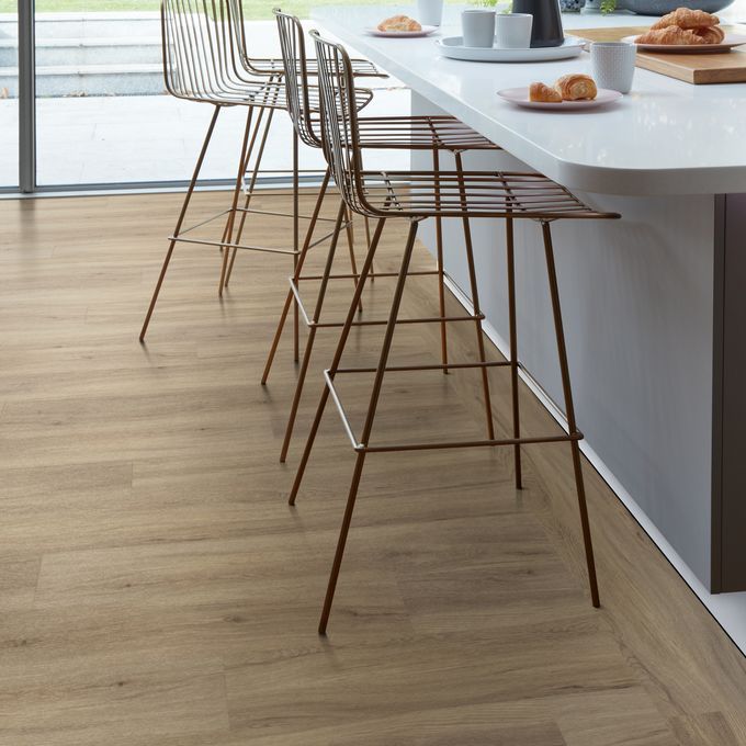 Breakfast bar with stools featuring light wood effect flooring 