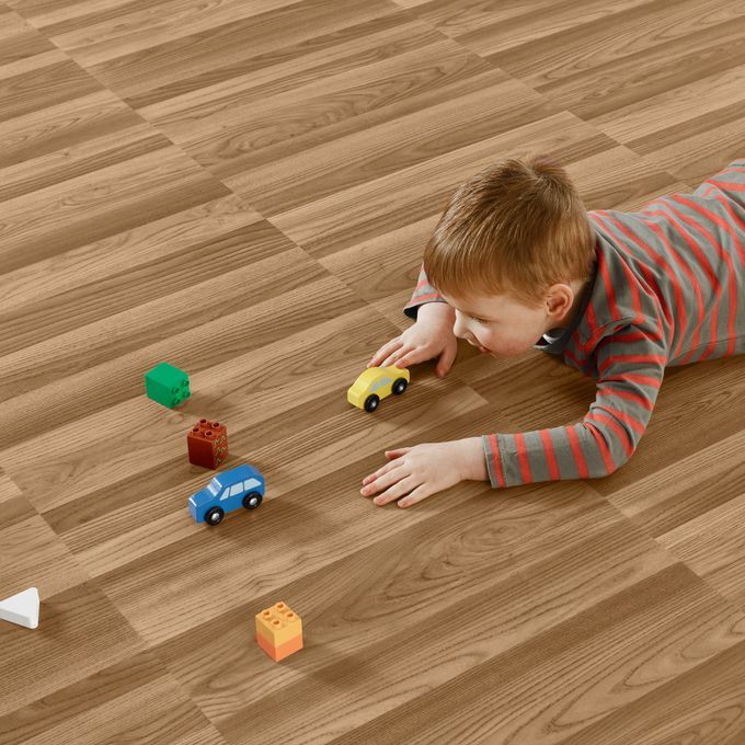 Little boy playing with cars featuring a ash wood effect flooring 