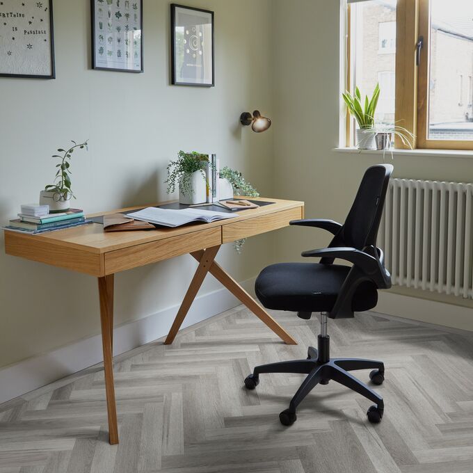 Grey coloured oak effect large parquet flooring with an office desk and chair