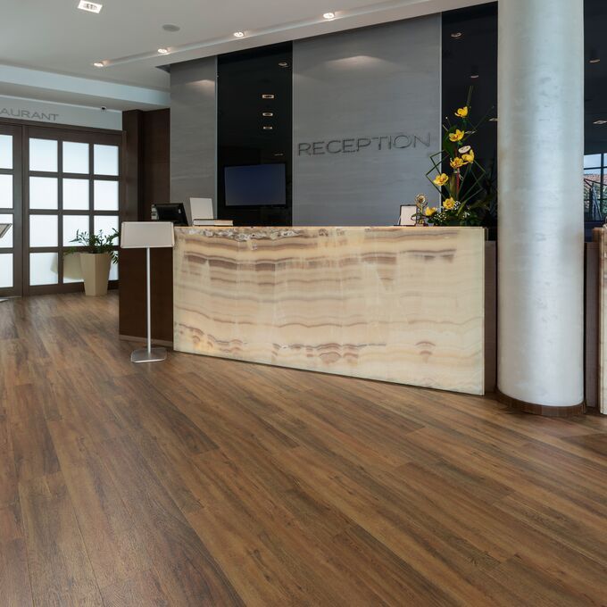 Reception area, Reception desk, large windowed door, dark oak style flooring 