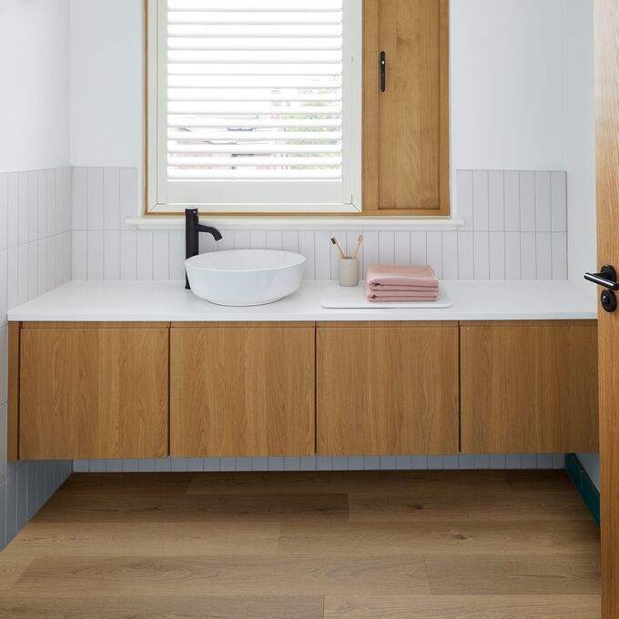Oak effect flooring in a residential bathroom decorated in a scandi vibe