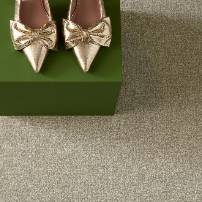Polyflor Expona Fabrik in Ecru next to a pair of high heels