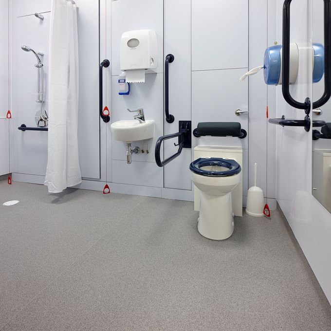 Grey safety floooring in a disabled toilet and shower room 