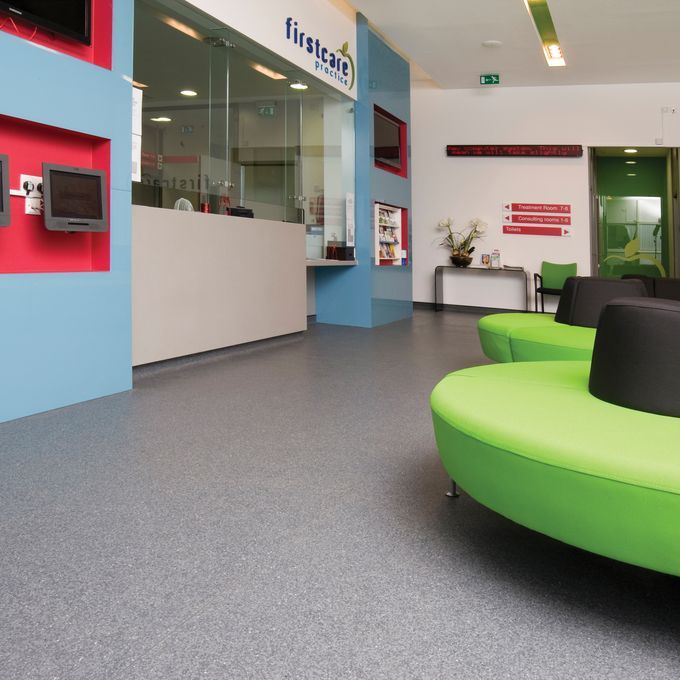Dark grey flooring in a doctors waiting area