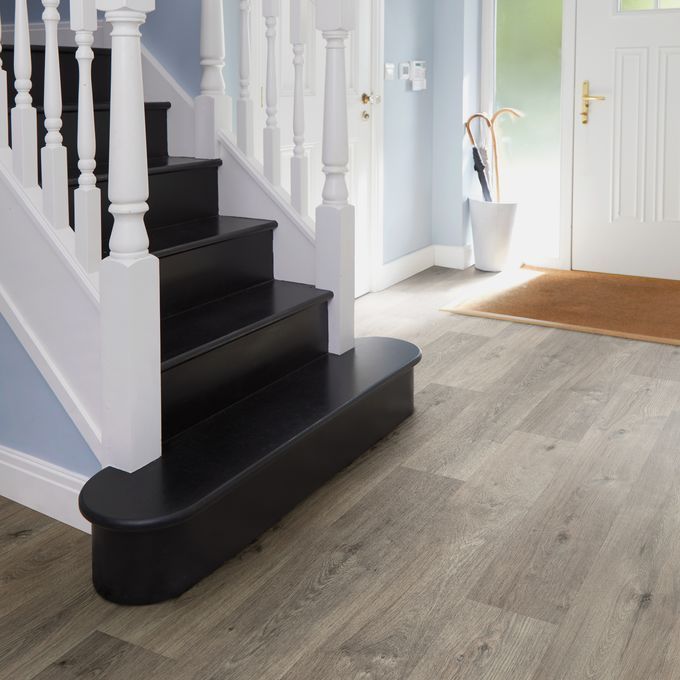 Dark oak effect flooring in a large hallway 