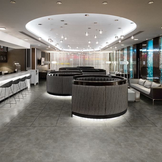 Grey limestone effect flooring in a modern bar area with seating booths 