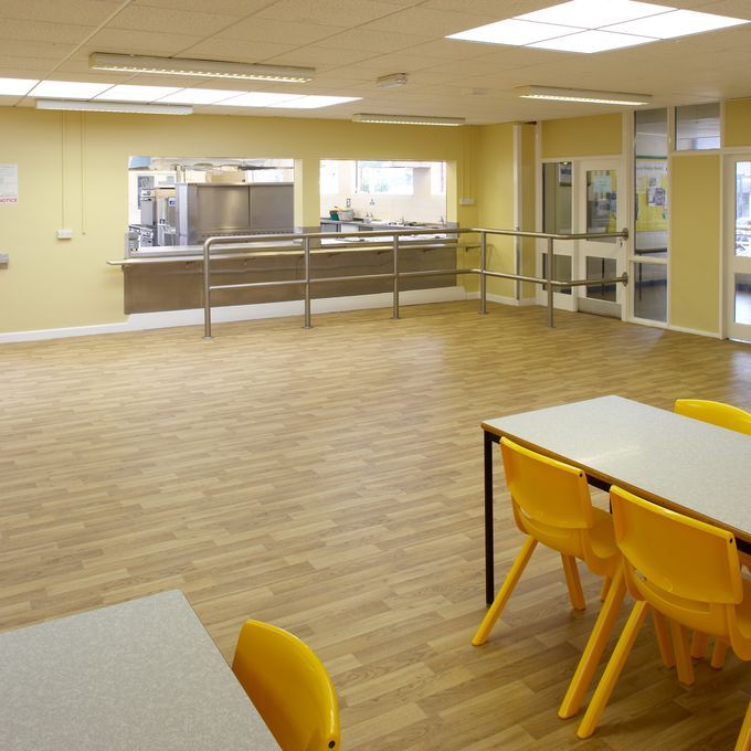 Rustic oak wood effect flooring in a school canteen