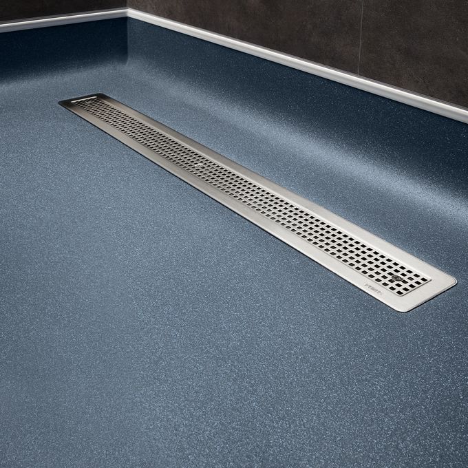 Dark blue safety flooring featured around a shower drain 